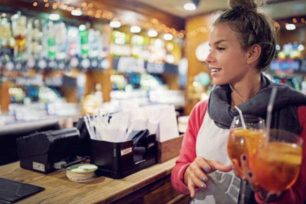 istock Young woman is taking her cocktails in a bar 1224256217
