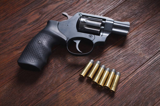 istock illegal handgun on wooden table 1224256240