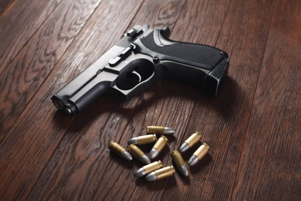 istock illegal handgun on wooden table 1224256242