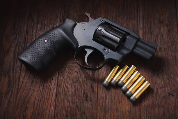 istock illegal handgun on wooden table 1224256244