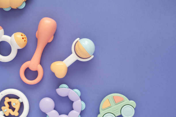 istock Flat lay composition with baby rattles set in pastel colors and space for text on light purple background. 1224257126