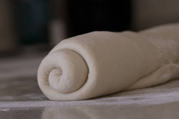 istock Rolled bread dough on a floured kitchen counter waiting to be shaped into a loaf of bread. 1224258066