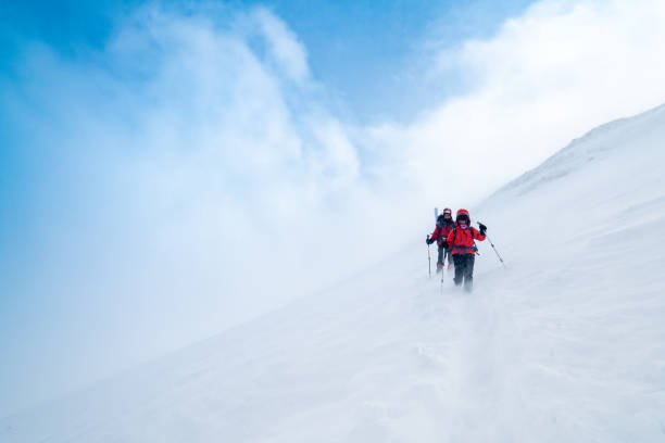 istock Mountain alpine climbing team is moving down in the high altitude mountain peak in blizzard 1224258721