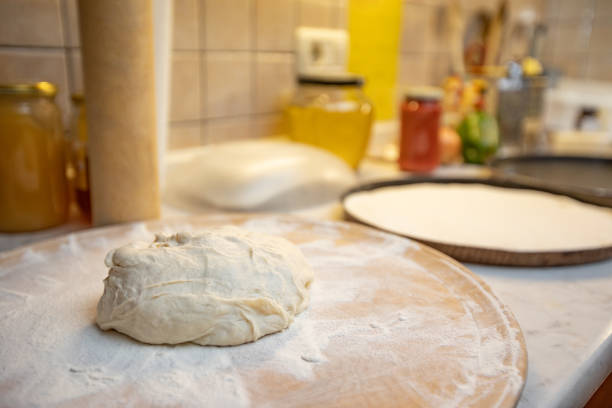 Homemade Pizza Dough on Wooden Cutting Board.