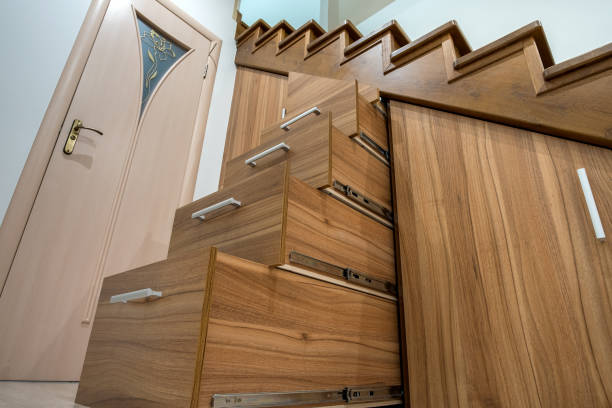istock Modern architecture interior with luxury hallway with glossy wooden stairs in multi-storey house. Custom built pullout cabinets on glides in slots under stairs. Use of space for storage. 1224260889