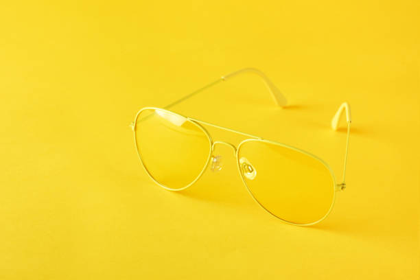 istock Yellow sunglasses on paper background, minimalism, monochrome. 1224263710