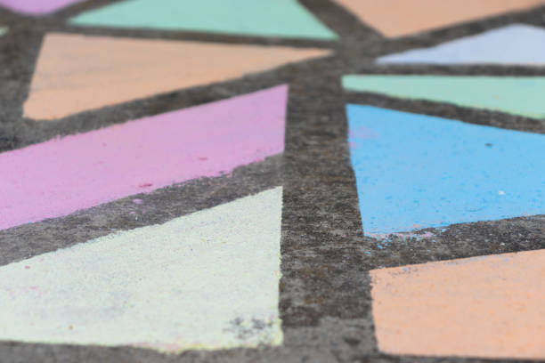 istock Brightly colored geometric shapes drawn in chalk along a side walk. 1224264608