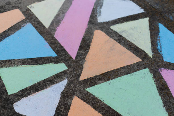istock Brightly colored geometric shapes drawn in chalk along a side walk. 1224264610
