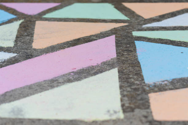istock Brightly colored geometric shapes drawn in chalk along a side walk. 1224264611