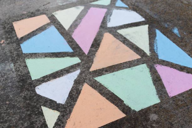 istock Brightly colored geometric shapes drawn in chalk along a side walk. 1224264619