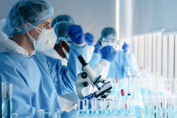 istock caucasian biological research scientist and team working together in vaccine development laboratory to develop coronavirus covid-19 vaccine, selective focused 1224267206