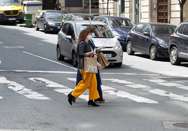 Buyers of 'Zara', in the center of Coruña, after reopening today after being closed by the covid-19 Coruña-Spain. Buyers of 'Zara', in the center of Coruña, after reopening today after being closed by the covid-19 coronavirus on May 7, 2020. named animal stock pictures, royalty-free photos & images