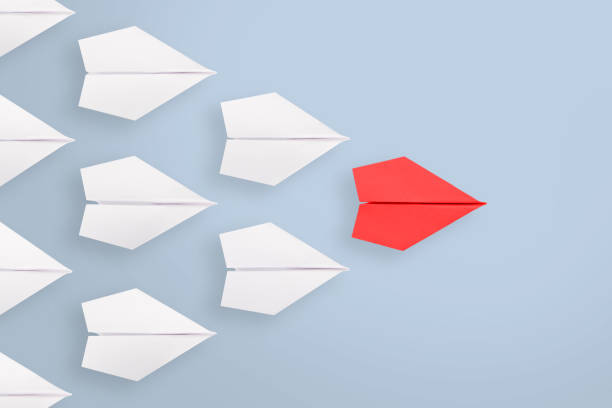 istock Leadership concepts with red paper airplane leading among white 1224268713
