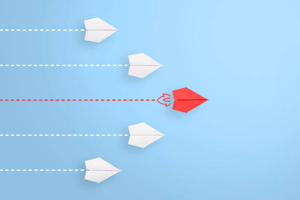 istock Leadership concepts with red paper airplane leading among white 1224269602