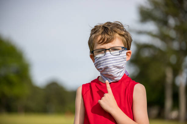 istock Child points to mask covering face 1224282199
