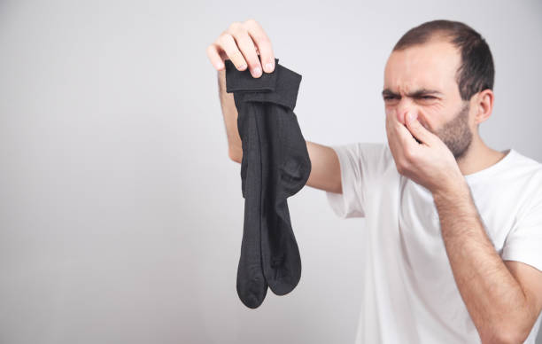 istock Bad smelly socks. Man closes the nose 1224284837