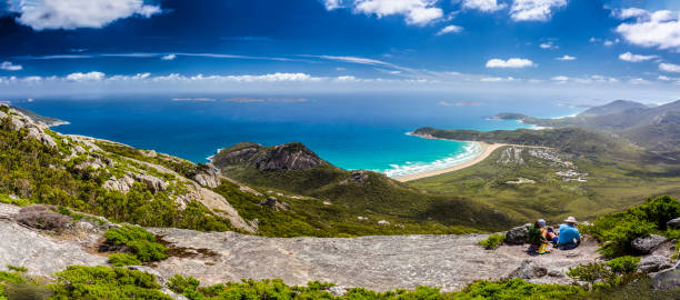 Hikers having lunch and enjoying the view from the summit of Mount Oberon at Wilsons Promontory stock photo
