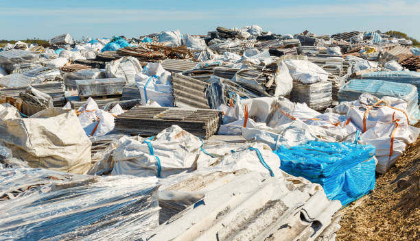 Asbestos landfill . Roof covering material with asbestos fibres . Asbestos roof removal . Dangerous asbestos dust and fibres in the environment . Health problems stock photo