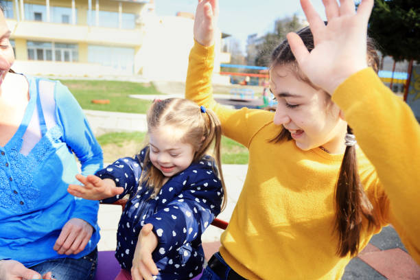 istock Mother and her two daughters having fun in a playground 1224291939