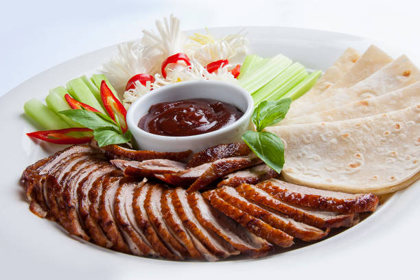 Duck in Beijing with cucumbers and pancakes. Sliced in pieces Duck in Beijing with cucumbers and pancakes. Sliced in pieces hoisin sauce stock pictures, royalty-free photos & images