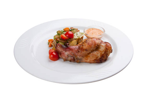 istock Chicken leg with baked vegetables. On a white plate 1224294134