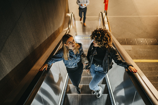 Female friends on subway escalator