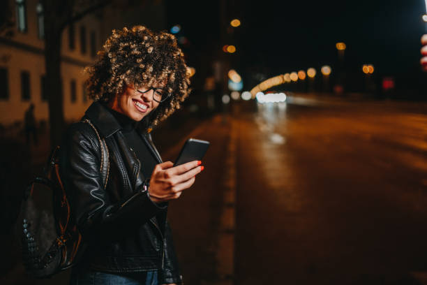istock Woman texting on city street 1224295529
