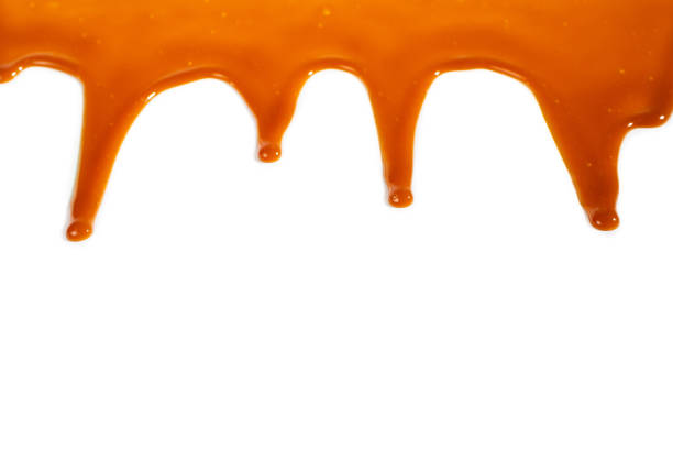 istock Background of flowing caramel sauce isolated on white. 1224296542