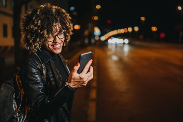 istock Woman texting on city street 1224296830