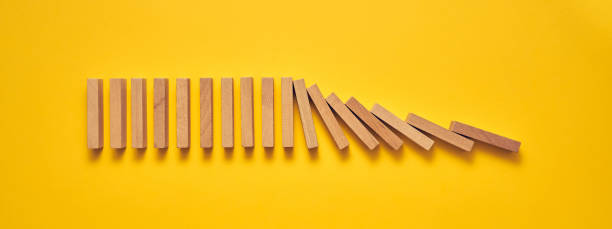 istock Wooden domino blocks arranged in a conceptual image 1224297100