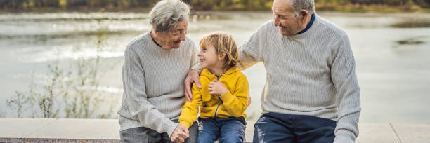 senior couple with baby grandson in the autumn park. great-grandmother, great-grandfather and great-grandson banner, long format - great grandchild imagens e fotografias de stock