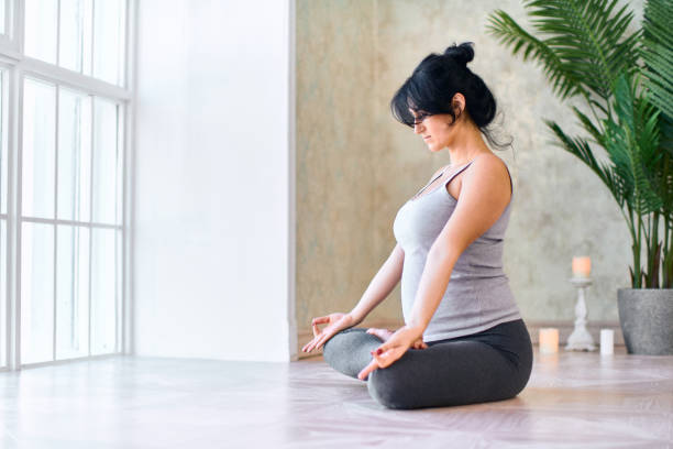 istock Doing Yoga Lotus exercises at home 1224298960