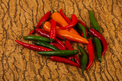 Chili pepper heap over wooden background
