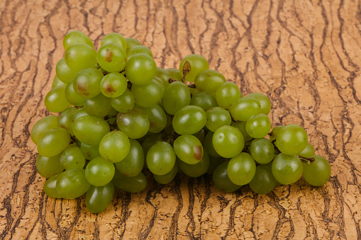 Sweet green grape branch over background