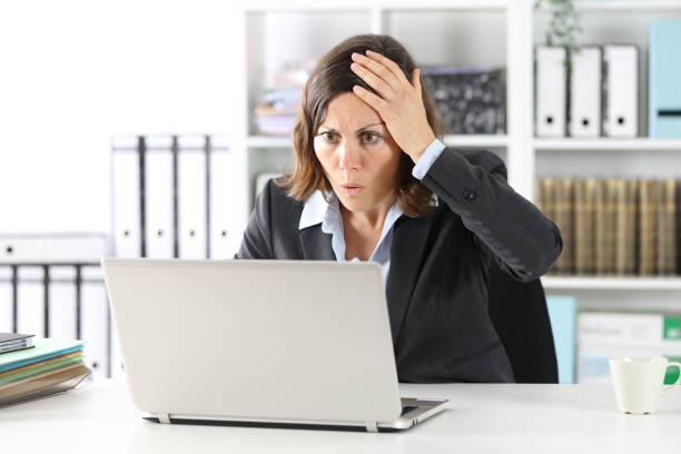 istock Surprised executive lady making mistake on laptop at office 1224303017