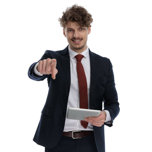 istock Happy businessman holding tablet, smiling and pointing 1224303204