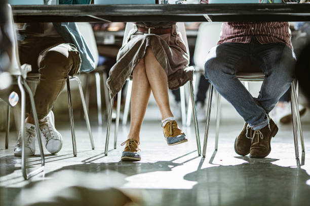 istock Unrecognizable people's legs under the table in the office. 1224303491