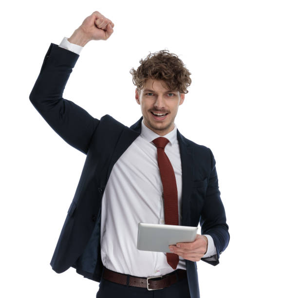 istock Cheerful businessman holding tablet, celebrating and smiling 1224303561