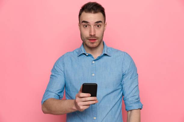 istock sexy surprised casual man standing and looking at camera 1224304409