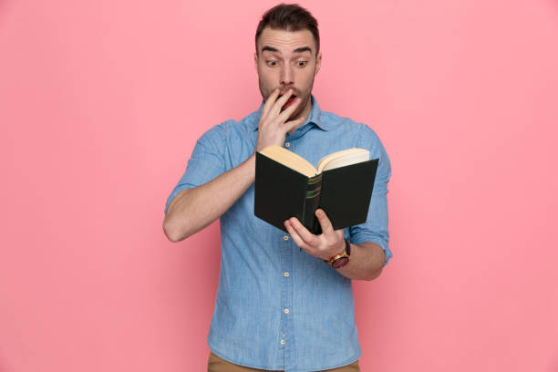 istock casual man reading his book and touching his face 1224304482