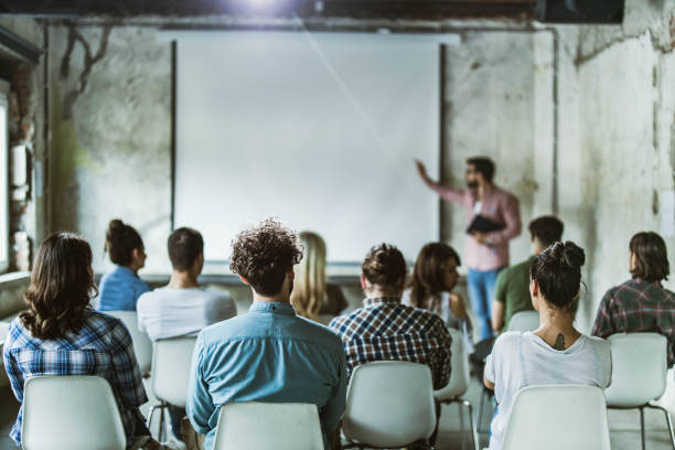 istock Back view of design professionals having training class in the office. 1224304486
