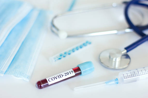 istock Coronavirus blood test, syringe and protective masks on white background. 1224304514