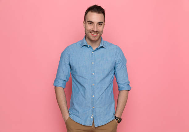 istock casual man standing with his hands in pocket, smiling 1224304695