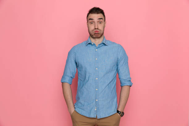 istock casual man puffing cheeks, standing with his hands in pocket 1224304709