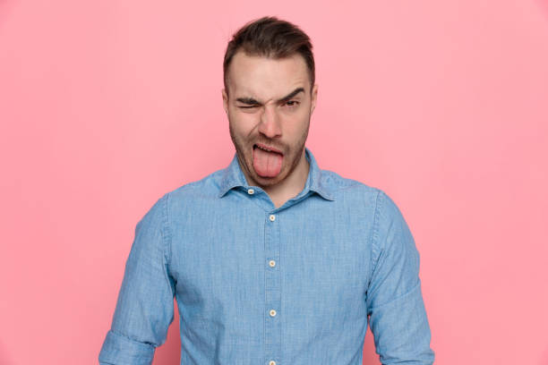 istock casual man is making faces, sticking his tongue out 1224304736