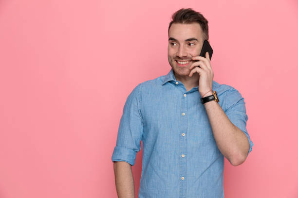 istock casual man talking on the phone, looking aside and smiling 1224305617