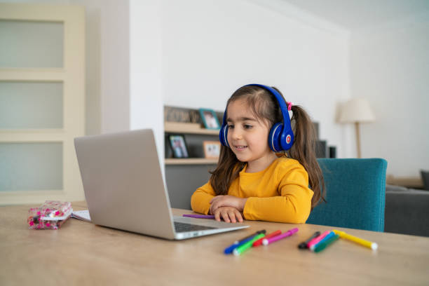 little girl homeschooling and distance learning at home - child computer laptop little girls imagens e fotografias de stock