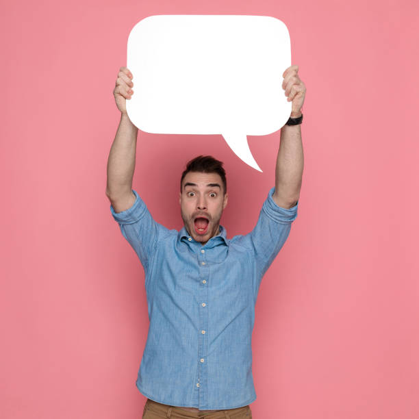 istock casual man holding a speech bubble overhead 1224306737