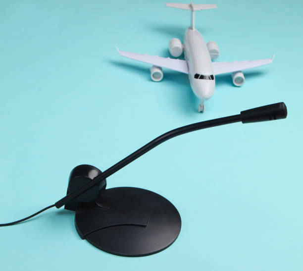 istock Air traffic controller, flight dispatcher. Plane figurine, microphone on blue background 1224308797