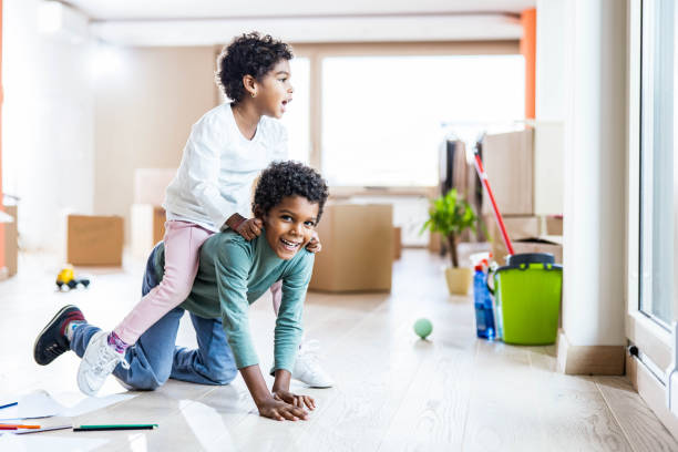 istock Playful African American kids having fun while moving into new home. 1224309598